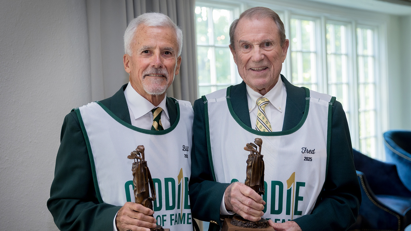 Fred Blesi and Bill Doyle receive their Caddie Hall of Fame statues